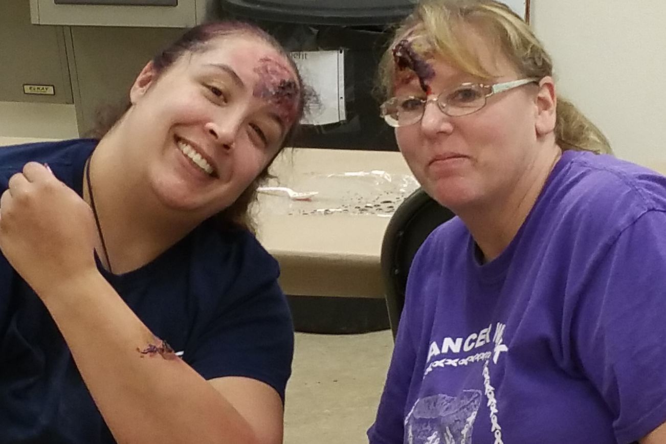 Heather Worley, Grays Harbor County CERT Program manager and Kim Shelley from GHFD No. 8, show off some moulage artistry at last spring’s moulage training event in Pacific Beach. Photo courtesy Grays Harbor County CERT.