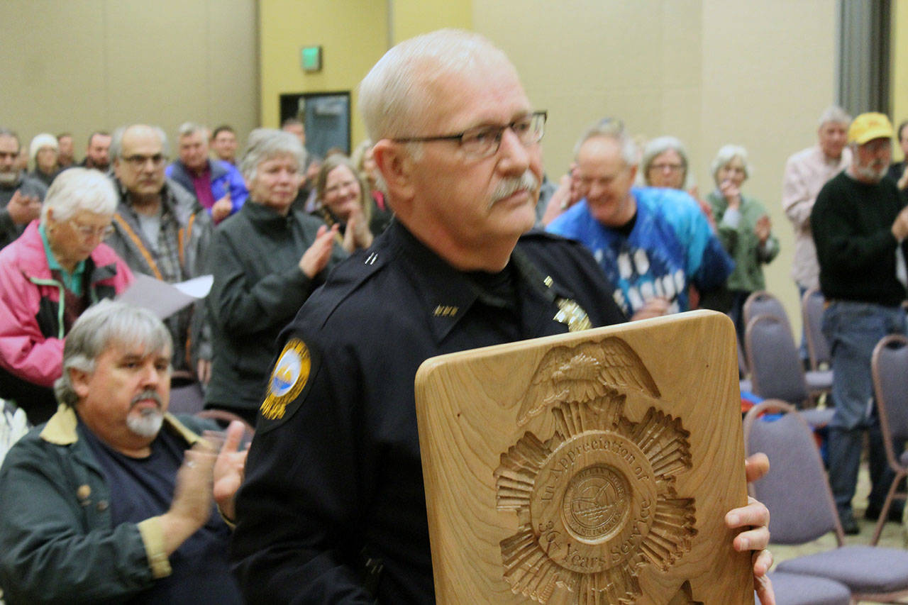 North Coast News: Retiring Ocean Shores Police Chief Mike Styner receives a standing ovation and shows the plaque he received in a ceremony before the City Council.