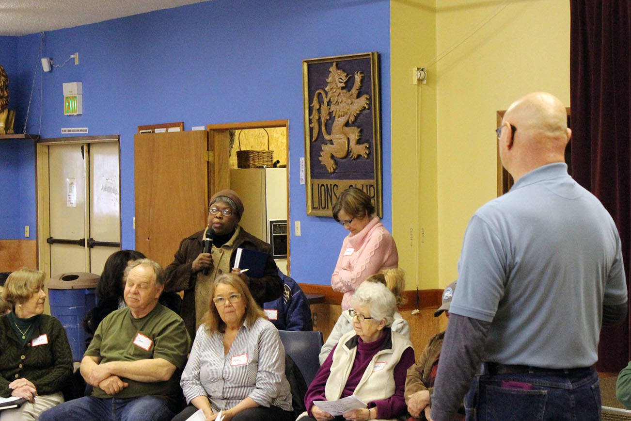 North Coast News photo                                Doreen Cato asks a question with Richard Wills, standing, as one of the moderators during a Town Hall on March 26 at the Ocean Shores Lions Club.