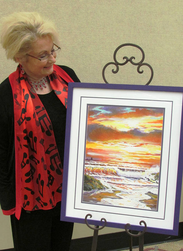 Raymond area artist Kris Jenott with her acrylic painting that won the poster contest for this year’s Fine Art, Photography and 3D Art Show at the Ocean Shores Convention Center.