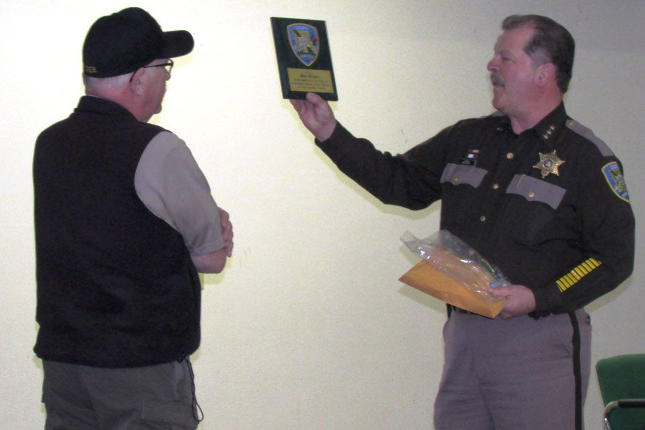 Scott D. Johnston photo: Retiring Ocean Shores Police Chief Mike Styner, left, is given an award from Grays Harbor County Sheriff Rick Scott.