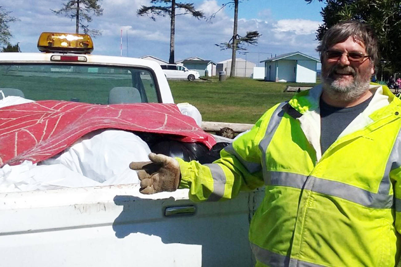 Jay Dudley of the city Public Works department hauls away a truckload of trash from the roadside cleanup sponsored by the Ocean Shores Block Watch Group at North Bay Park.