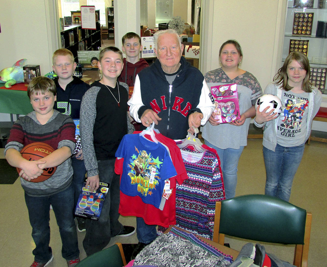 Scott D. Johnston | For twin harbors Newspaper Group                                “Santa Joe” Cornell is popular with the kids as he brings Christmas cheer to 23 schools throughout Grays Harbor County. Last Friday, he brought a carload of new toys, clothes and school supplies to Ocean Shores Elementary School.