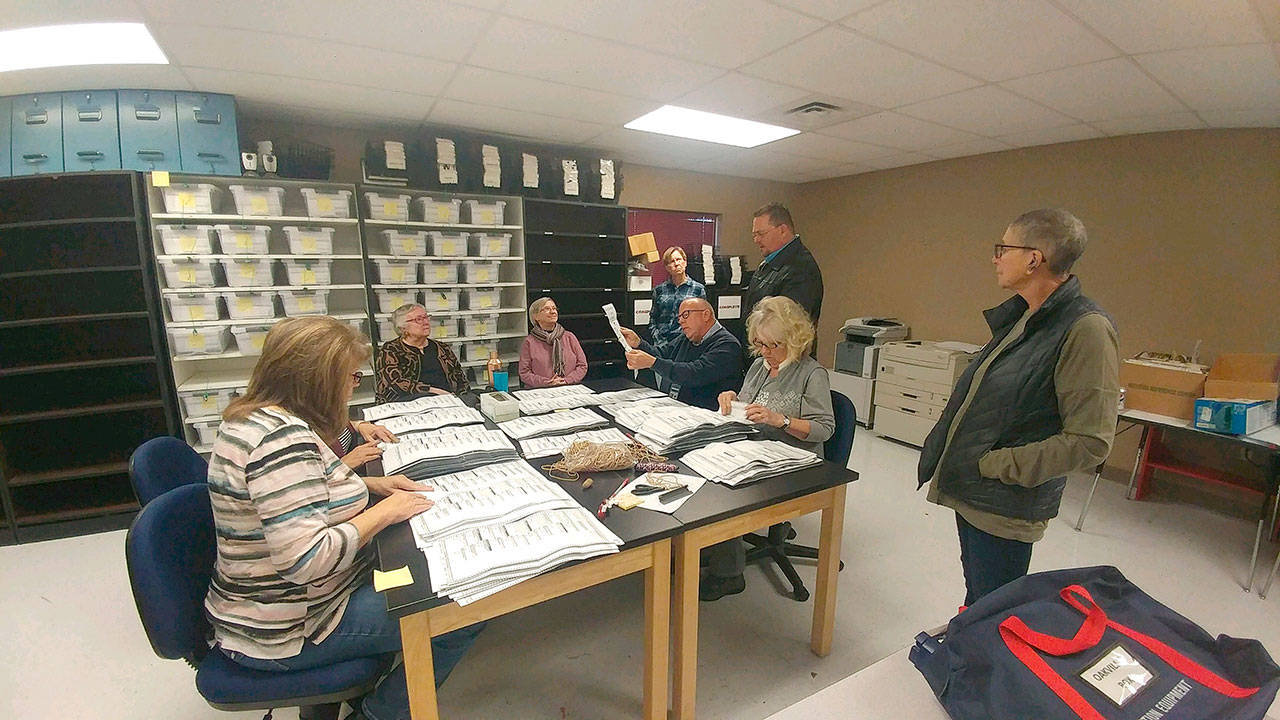 Auditor’s Office election workers hand count ballots in the Ocean Shores mayoral race Tuesday. Candidates Crystal Dingler (second from left) and Susan Conniry (far right) were there throughout the day. County Auditor Joe MacLean is pictured standing at the right side of the table. (Thorin Sprandel | Grays Harbor News Group)