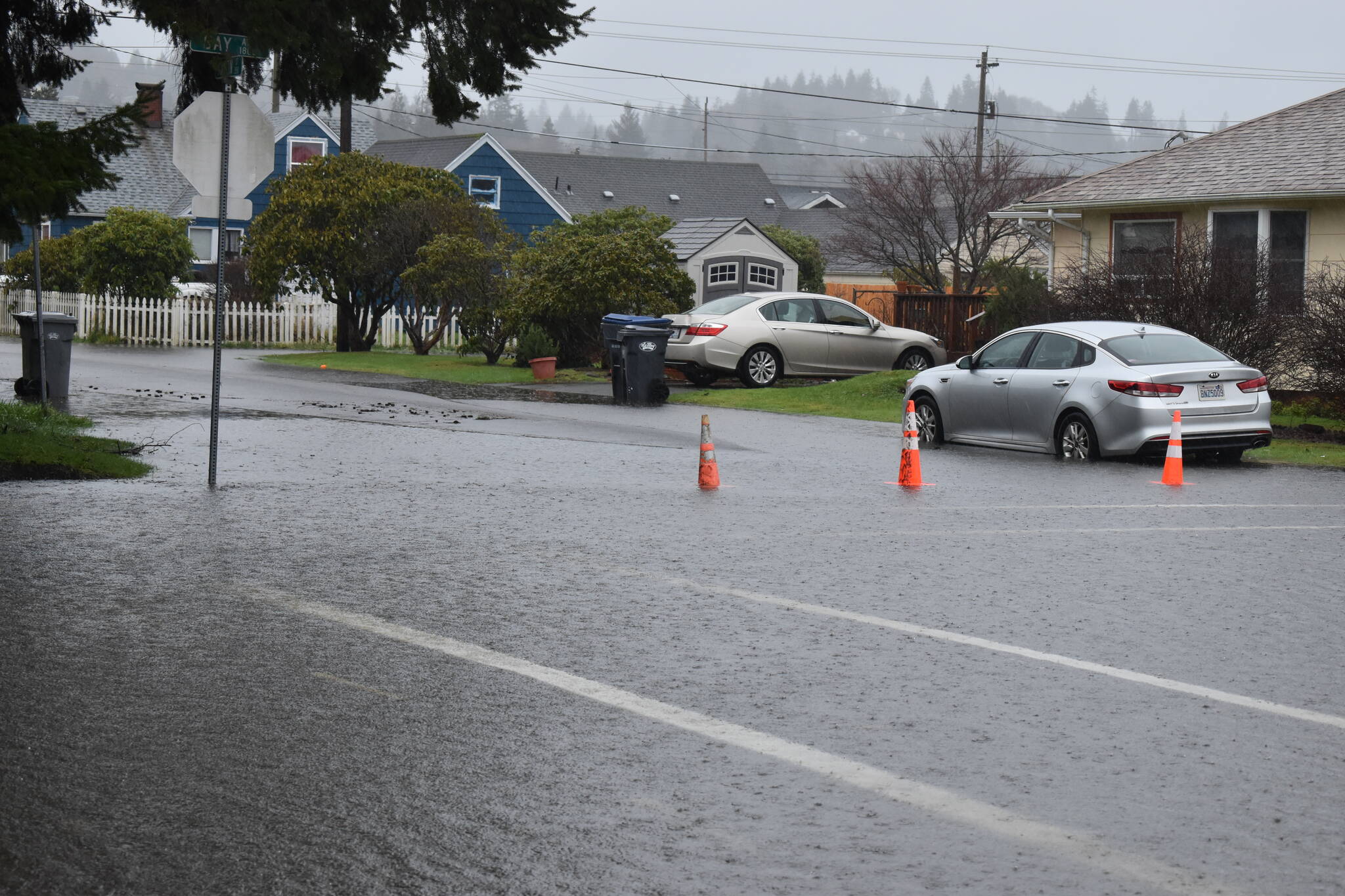 Orange traffic cones on Thursday, Jan. 6, 2022, block drivers from heading down the then-flooded Bay Avenue near A.J. West Elementary School, in Aberdeen. Grays Harbor County commissioners approved $30,000 for flood vouchers to help county residents clean up their flood debris. (Matthew N. Wells | The Daily World)