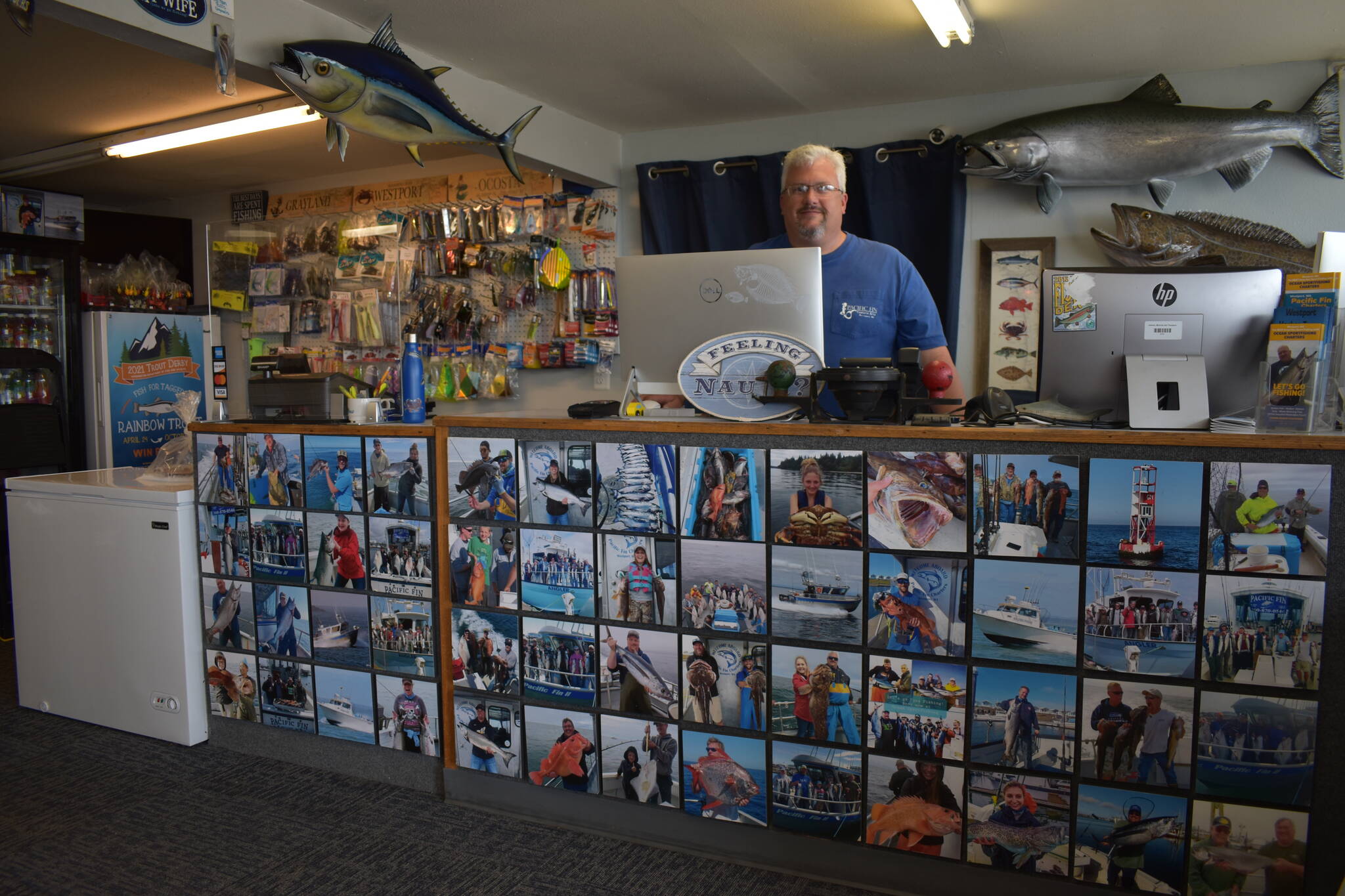 Matthew N. Wells | The Daily World
                                Eric McMurry, owner of Ocean Sportfishing Charters, stands behind a counter that features all local catches from past years in and around Westport. The Westport community is learning to integrate traditional industry into its tourism offerings to create unique and authentic experiences in Grays Harbor.